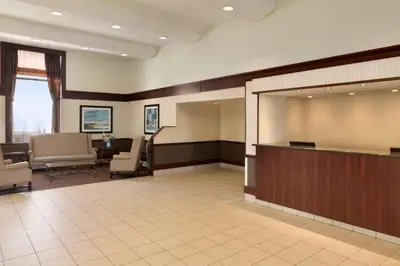 a large lobby with a waiting area with chairs and a waiting room at Travelodge by Wyndham Edmonton South in Edmonton