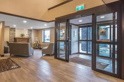 a lobby with a waiting area with a door open at Comfort Inn in Chilliwack
