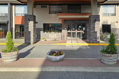 a building with two large pots of flowers in front of it at Comfort Inn in Chilliwack