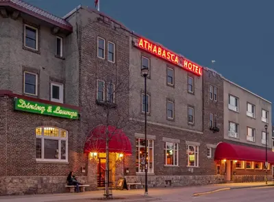 a large brick building with a sign on it at Athabasca Hotel in Jasper