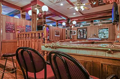 a bar with two chairs in a restaurant at Athabasca Hotel in Jasper