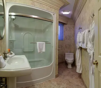 a bathroom with a shower and a sink and a toilet at Athabasca Hotel in Jasper