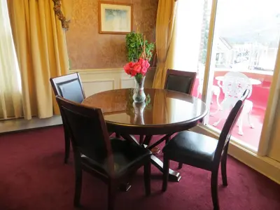 a dining room table with a vase of flowers on it at Athabasca Hotel in Jasper