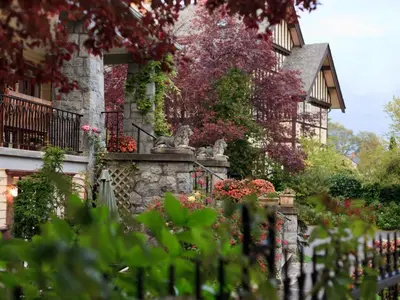 a garden in front of a house with flowers at Abbeymoore Manor in Victoria