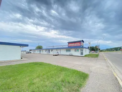 an empty parking lot in front of a building at Shannon Motel in Fort Nelson