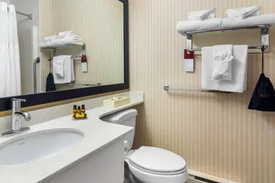a bathroom with a toilet and a sink and a mirror at Best Western Plus Osoyoos Hotel & Suites in Osoyoos