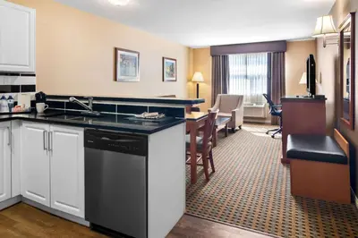 a hotel room with a kitchen and a living room at Best Western Plus Osoyoos Hotel & Suites in Osoyoos