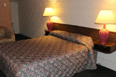 a hotel room with a bed and two lamps at Best Continental Motel in Hope