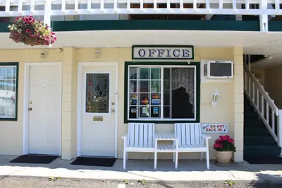an office with two white benches outside of a building at Best Continental Motel in Hope