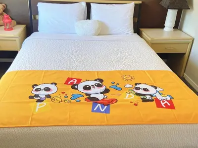 a bed with a blanket with hello kitty on it at Slumber Lodge in Hope