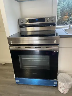 a black oven in a kitchen with a sink at Slumber Lodge in Hope