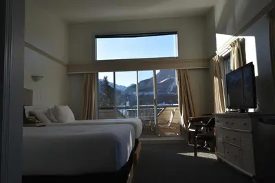 a hotel room with a bed and a large window at The Drake Inn in Canmore