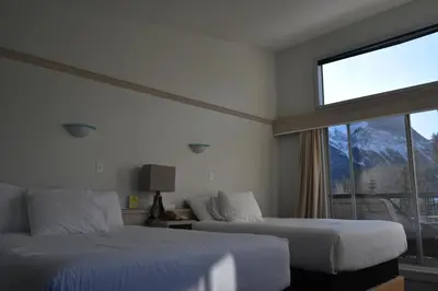 a hotel room with two beds and a window at The Drake Inn in Canmore