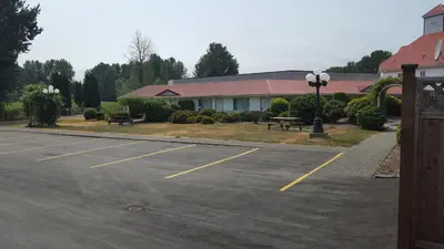 a parking lot in front of a building at Rainbow Motor Inn in Chilliwack