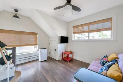 a living room with a purple couch and a window at Minimal - 90 nights min in Vancouver