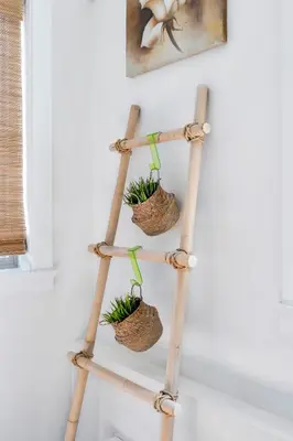 a bamboo plant rack with three baskets on it at Minimal - 90 nights min in Vancouver