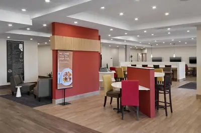 a restaurant with tables and chairs and a bar at TownePlace Suites by Marriott Edmonton Sherwood Park in Sherwood Park