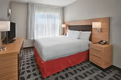 a hotel room with a bed and a flat screen tv at TownePlace Suites by Marriott Edmonton Sherwood Park in Sherwood Park