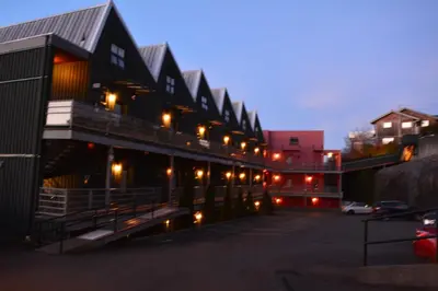a building with lights in a parking lot at night at Island Village Properties at Fred Tibbs in Tofino