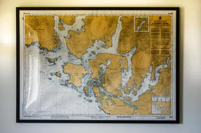 a map hanging on a wall at Island Village Properties at Fred Tibbs in Tofino