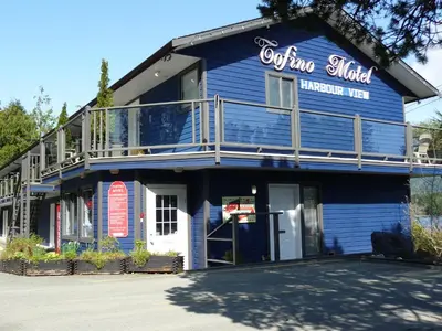 a blue building with a sign that reads otina middle inventory inn at Tofino Motel Harbourview in Tofino