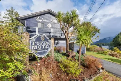 a house with a sign in front of it at Tofino Motel Harbourview in Tofino