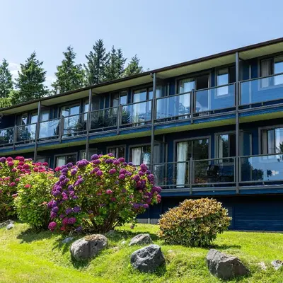 an apartment building with flowers in front of it at Tofino Motel Harbourview in Tofino