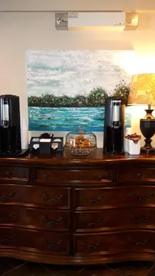 a dresser in a room with a painting on the wall at Super 8 by Wyndham Cochrane in Cochrane