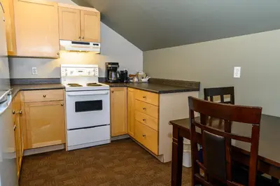 a small kitchen with a white stove top oven at Super 8 by Wyndham Cochrane in Cochrane