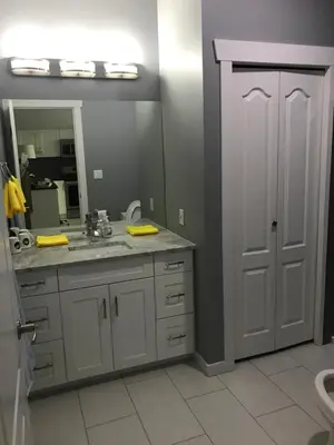 a bathroom with a sink and a mirror at Lake and Bridge View Vacation Home in West Kelowna
