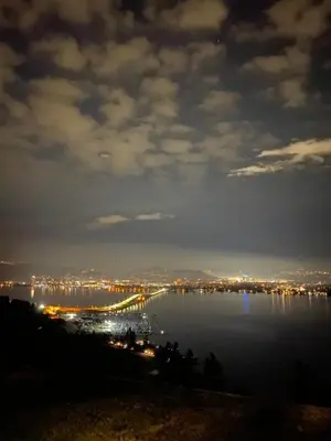 a view of a large body of water at night at Lake and Bridge View Vacation Home in West Kelowna
