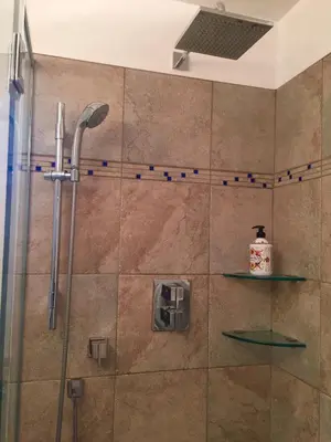 a shower in a bathroom with a glass door at Lee home in Vancouver