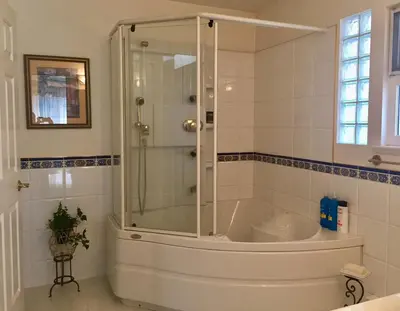 a shower with a glass door in a bathroom at Lee home in Vancouver