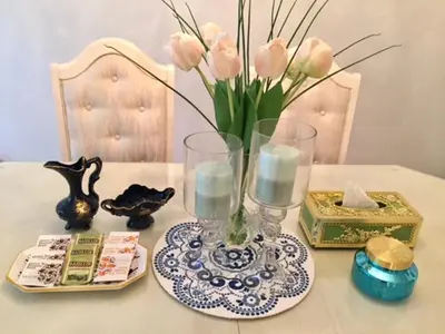 a table with a vase with pink flowers in it at Lee home in Vancouver