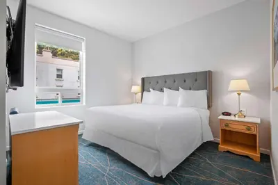 a bedroom with a large white bed and a window at Crown Columbia Hotel; BW Premier Collection in Trail