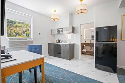 a kitchen with a table and a counter top at Crown Columbia Hotel; BW Premier Collection in Trail
