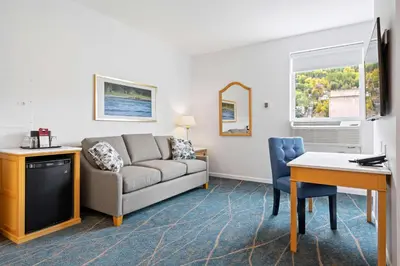 a living room with a couch and a table at Crown Columbia Hotel; BW Premier Collection in Trail