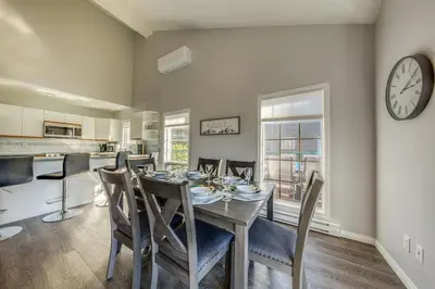 a dining room with a table and chairs and a clock at Marble Canyon in Fairmont Hot Springs