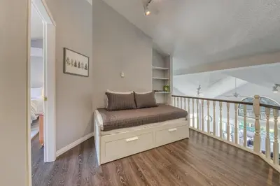 a bed in a room with a stair case at Marble Canyon in Fairmont Hot Springs