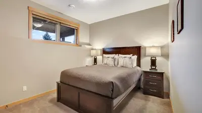 a small bedroom with a bed and a window at The Residences at Fairmont Ridge in Fairmont Hot Springs