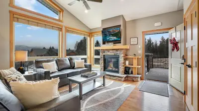 a living room with a couch and a fireplace at The Residences at Fairmont Ridge in Fairmont Hot Springs