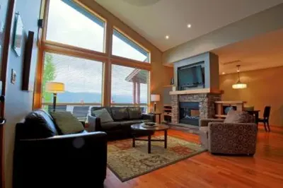 a living room filled with furniture and a fireplace at The Residences at Fairmont Ridge in Fairmont Hot Springs