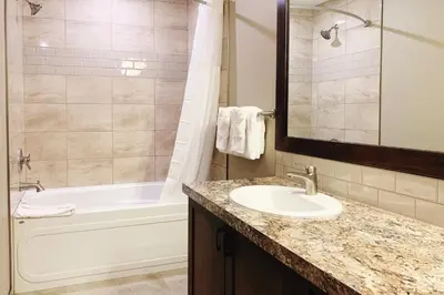 a bathroom with a sink and a bath tub at The Residences at Fairmont Ridge in Fairmont Hot Springs