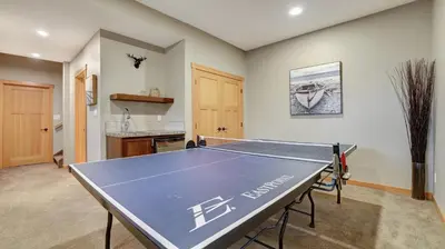 a ping pong table in the middle of a room at The Residences at Fairmont Ridge in Fairmont Hot Springs