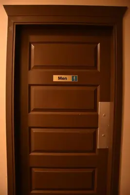 a door with a sign that says men on it at PARTY HOSTEL - The Canmore Hotel Hostel in Canmore