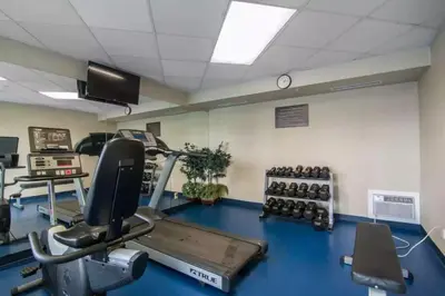 a fitness room with a treadmill and weights at Comfort Inn & Suites South in Calgary