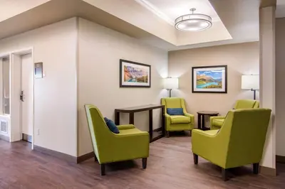 a waiting room at a hospital with chairs and a table at Comfort Inn & Suites in Red Deer
