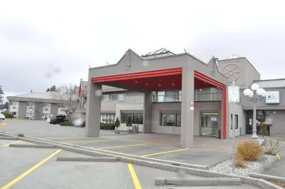 a parking lot in front of a building at Ramada by Wyndham Abbotsford in Abbotsford