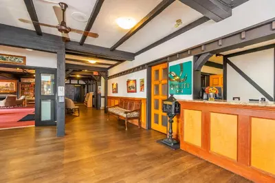 a large room with a bar and a living room at Quality Inn Waddling Dog in Saanichton