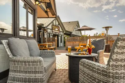 two chairs and a table on a patio at Quality Inn Waddling Dog in Saanichton